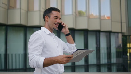 Relaxed boss talking phone call walking business building background closeup
