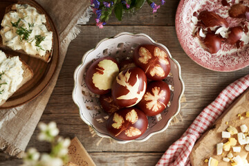 Easter eggs dyed with onion skins, with slices of sourdough bread with spread made from leftover...