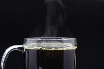 Hot cup of coffee on a dark background