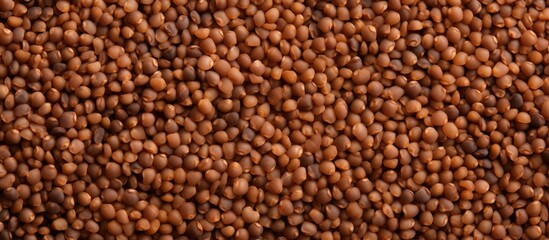 An intimate view of a heap of light brown beans scattered across a wooden tabletop