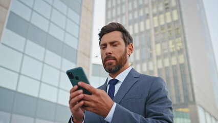 Financial manager browsing app looking smartphone screen on street close up. 