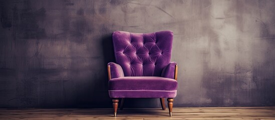 A comfortable purple chair sits on hardwood flooring in front of a violet wall, creating a...
