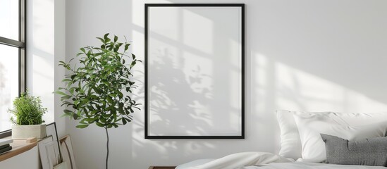 White poster in a black wood frame hanging on a white wall