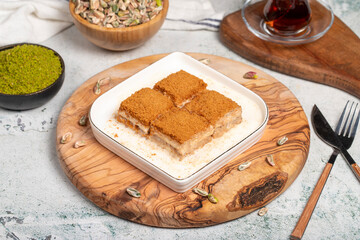 Baklava with biscuits and milk. Cold baklava with biscuits on a wooden serving board. Famous dishes of Turkish cuisine