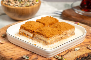 Baklava with biscuits and milk. Cold baklava with biscuits on a wooden serving board. Famous dishes of Turkish cuisine
