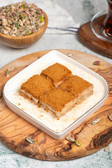 Baklava with biscuits and milk. Cold baklava with biscuits on a wooden serving board. Famous dishes of Turkish cuisine