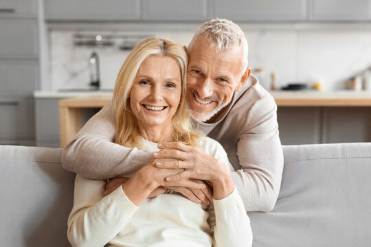 Mature couple smiling and hugging tightly