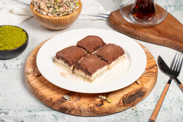 Dark chocolate and milk baklava. Cold baklava with chocolate on a wooden serving board. Famous dishes of Turkish cuisine