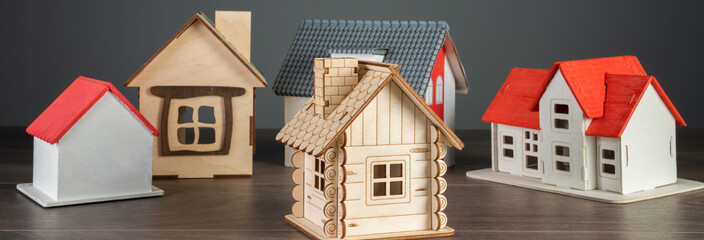 Small wooden decorative houses on table, studio background