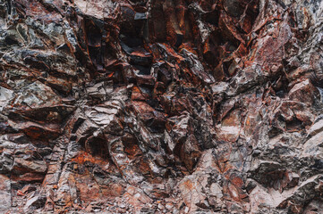 texture of an orange stone mountain with natural minerals in close-up