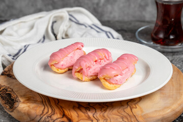 Strawberry cream eclair. Strawberry eclair dessert on wood serving board