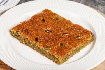 Kadayıf dessert with syrup. Traditional Turkish cuisine desserts. Kadayıf with pistachios on a...