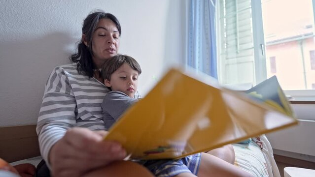 Captivated Child - Observes Illustrations As Mom Reads Story