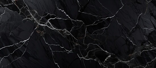 Close-up view of a sleek black marble slab featuring a prominent white vein running through it