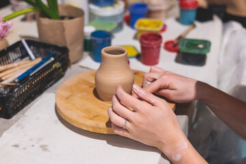 Pottery lesson master class for kids children, process of making clay pot on pottery wheel, potter hands creating ceramic crockery handcrafts, ceramist molding and painting jar or vase