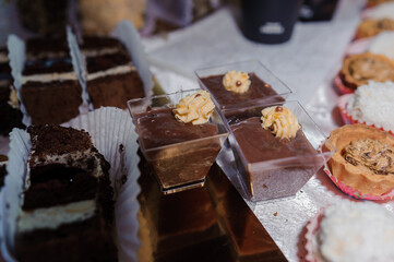 Sweet cakes at a wedding banquet. Catering, sweet festive buffet. Candy bar