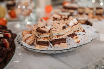 Sweet cakes at a wedding banquet. Catering, sweet festive buffet. Candy bar