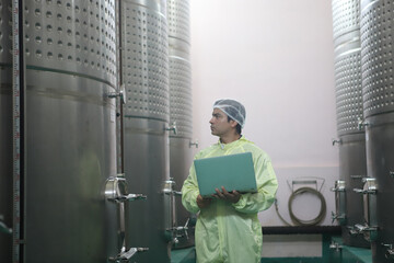 Winemaker working in modern large winery factory drink industry  and  testing wine in a wine factory warehouse - 769180624