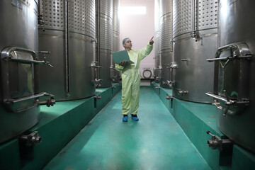 Winemaker working in modern large winery factory drink industry  and  testing wine in a wine factory warehouse - 769180837