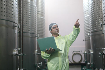 Winemaker working in modern large winery factory drink industry  and  testing wine in a wine factory warehouse - 769180847