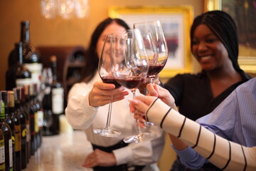 happy girls clinking glasses with wine at cafe or restaurant - 769182204