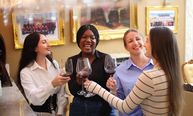 happy girls clinking glasses with wine at cafe or restaurant - 769182260