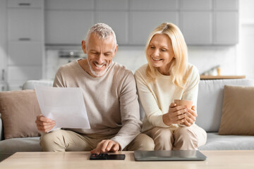 Happy couple reviewing financial document