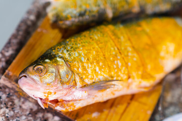 Preparation of bocachico fish with turmeric seasoning for lunch, seafood meal