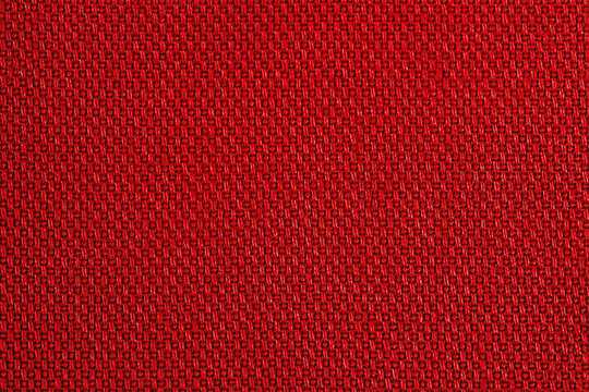 Red fabric as background macro photo. Fabric texture.