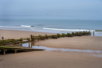 View of Happisburgh beach with sea defenses, North Norfolk, England
