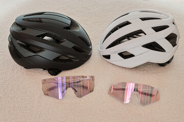 Cycling accessories. Cycling black and white helmets and sunglasses.