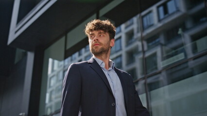 Man professional walking downtown in suit closeup. Confident ceo going street