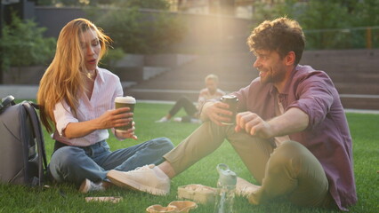 Happy couple enjoying picnic in urban park. Closeup woman relaxing closing eyes