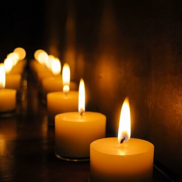 Burning candles on a dark background. Many candle lights glow on a dark background. Generative AI