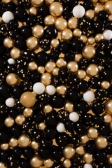 Featuring polystyrene balls background for a carnival celebration concept, black and gold colours, vertical