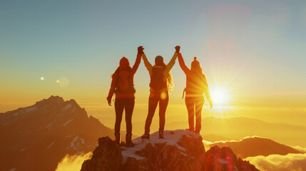 Three women, in backpacking clothes, stood on top of mountain, holding hands high celebrating the climb. Sunrise. Theme, overcoming obstacles. - obrazy, fototapety, plakaty
