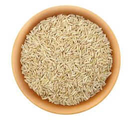 Brown rice in clay pot, uncooked and hulled, isolated on white, top view