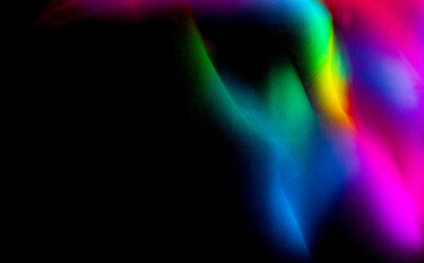 Abstract rainbow on textured black background. Long exposure. Light painting photography.