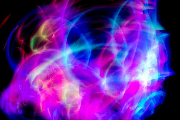 Abstract colorful irregular lines on black background and wall texture. Long exposure. Light painting photography.