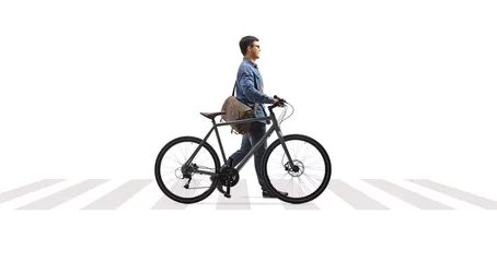 Poster Full length profile shot of a man crossing a street and pushing a bicycle © Ljupco Smokovski