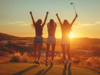  Three women are joyfully leaping in the sky with their arms raised, enjoying the natural landscape and feeling happy in the warm weather © RichWolf