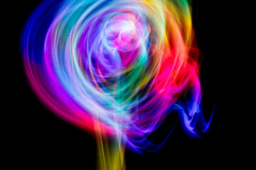 Abstract colorful irregular lines on black background and wall texture. Long exposure. Light painting photography.