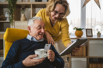 Couple mature senior man and woman husband and wife shopping online