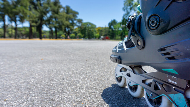 Rollerblading in a park on a summer afternoon with people around.