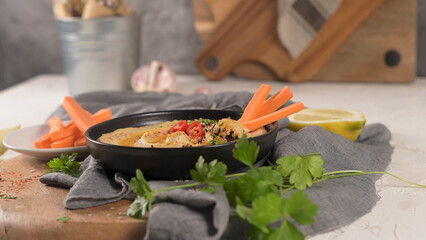 Delicious hummus in ceramic bowl