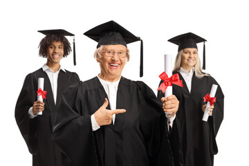 Graduation students and an elderly woman holding certificates and pointing