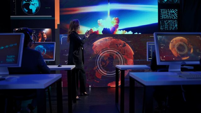 Earth control center, team monitoring space ship on big screen. Group of people in mission center watching rocket launch, clapping happy expression, winning gestures.