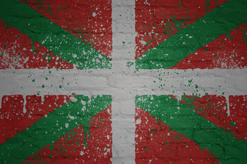colorful painted big national flag of basque country on a massive brick wall