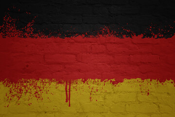 colorful painted big national flag of germany on a massive brick wall