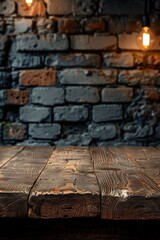 Fototapeta na wymiar Old wood table with blurred concrete block wall in dark room background 